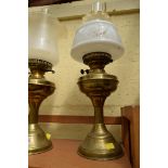 A set of three brass oil lamps.