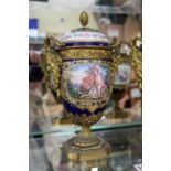 A good pair of Sevres style and ormolu mounted twin handled urns and covers,