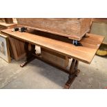 A 20th century oak trestle table and matching bench, the table 152.5cm long.