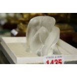 A Lalique frosted glass seated figure, 6.5cm high.