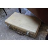 A vintage vellum or pigskin suitcase.