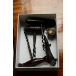 Three antique corkscrews; together with a novelty lighter; and an antler knife rest.