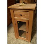 A contemporary pale oak pillar cupboard, 56.5cm wide.