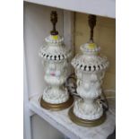 A pair of Continental pottery table lamps, (a.f.).