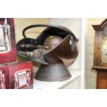 A Victorian copper coal scuttle; together with similar shovel and carved oak bellows.