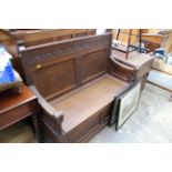 A Victorian carved oak box seat settle, 115cm wide.