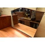 A circa 1960s walnut chest of drawers and matching mirror back dressing table, by Alfred Cox,