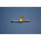 A 9ct gold bar brooch set single pearl.