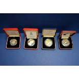 Four silver proof £5 commemorative coins,