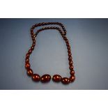 A cherry amber graduated bead necklace, 80cm, 75g.