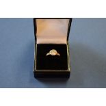 An 18ct gold diamond ring of approximately 1ct, the semi rub over setting in white,