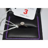 A 18k white gold diamond cluster ring, in Michael Matthews ring box.