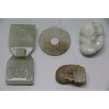 Four Chinese pale celadon jadeite carvings, comprising: a mottled bi disc, 5.