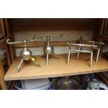 Two pairs of brass andirons, to include one pair in the style of Christopher Dresser.