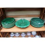 A collection of green majolica dessert plates.
