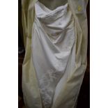 A full-length wedding dress labelled 'Miss Kelly, Paris', size 24, style 'Mandarin'.