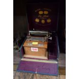 A vintage French walnut cigarette rolling machine, boxed.