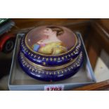 A Vienna style porcelain circular box and cover, the cover painted with a lady, indistinctly signed,