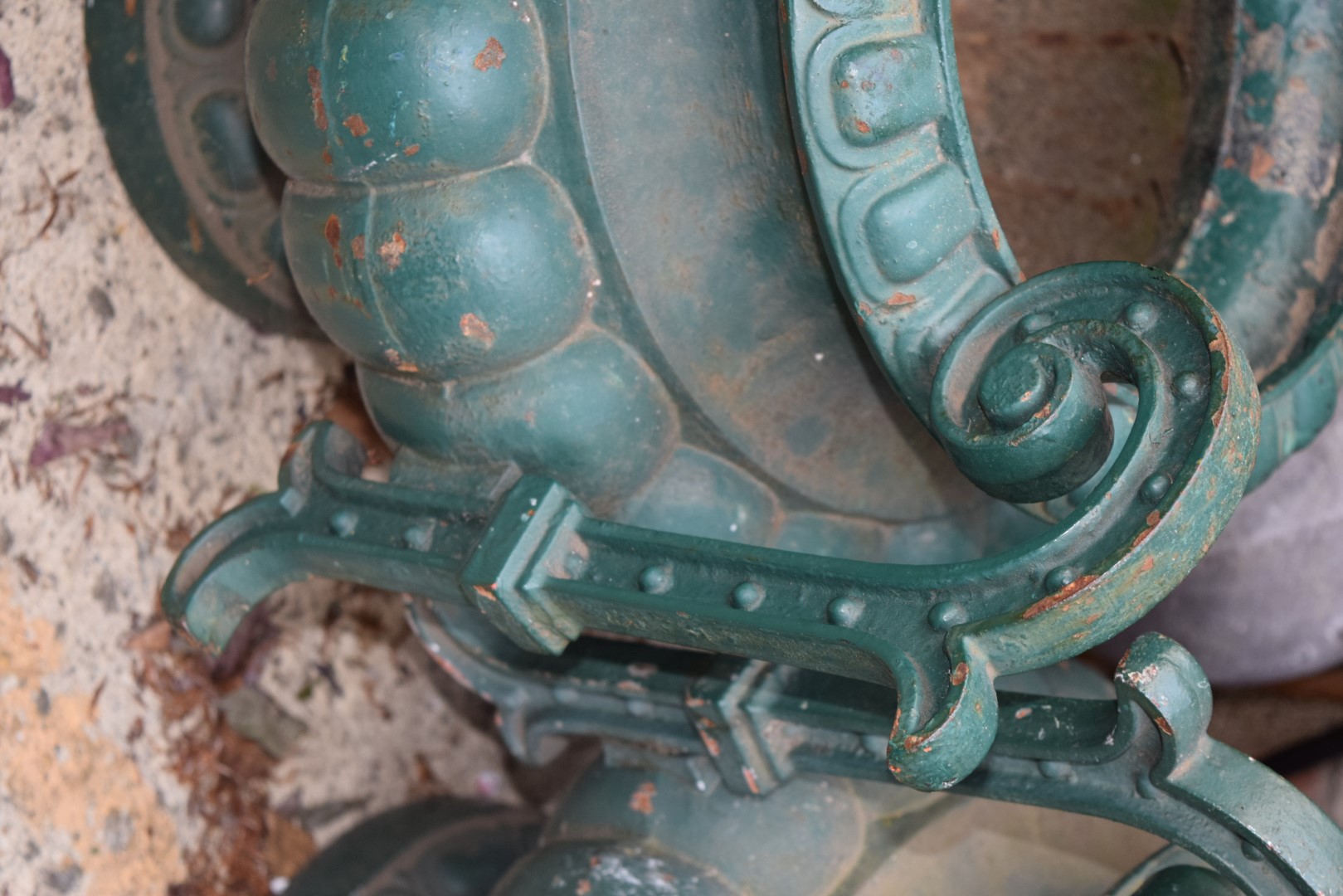 A pair of antique green painted cast iron twin handled urns, 48.5cm high. - Image 4 of 5