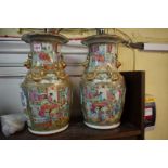 A pair of Chinese Canton famille rose twin handled vases, 35.