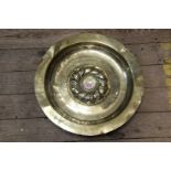 An 18th century Continental embossed brass alms dish, 44cm diameter.