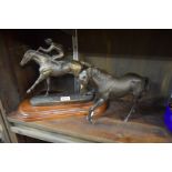 A Royal Doulton black stallion; together with another bronzed resin horse and jockey figure group.