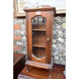 A walnut and glazed miniature cabinet, 58cm high.