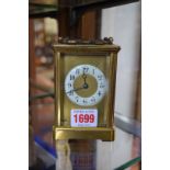 A brass carriage timepiece, height including handle 14.5cm.