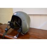 A green painted flight or tank helmet.