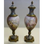A good pair of late 19th century Sevres, champleve enamel and gilt metal urns and covers,