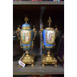 A pair of Sevres style gilt metal mounted twin handled urns, 30cm high, (one a.f.