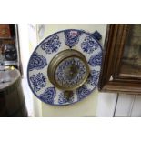 A French blue and white pottery framed wall clock, 38cm diameter.