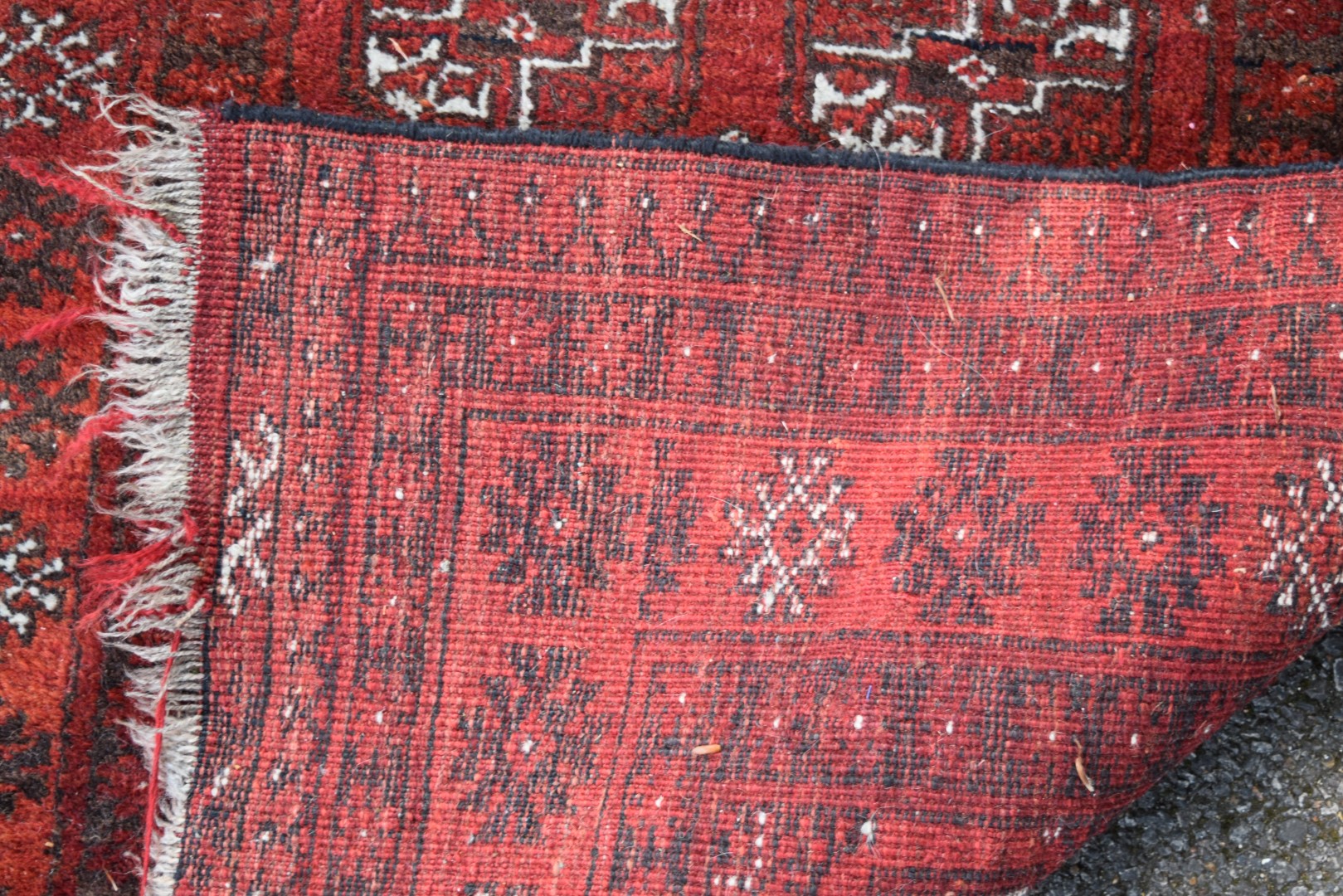 An Afghan rug, with gul design on a red field, 120 x 94cm. - Image 3 of 3