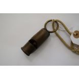 An unusual horn whistle, inscribed 'Rd 220935', with brass lanyard.