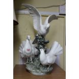 A large Lladro figure group of three doves, 53.5cm high.