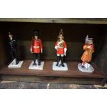 Four Royal Doulton 'Iconic London' figures, comprising: 'British Policeman', HN5365; 'Guardsman',