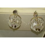 A pair of brass and faceted glass bag chandeliers.