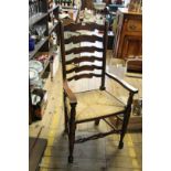 A set of seven beech and rush ladderback dining chairs,