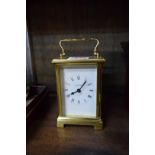 A brass carriage timepiece, height including handle 14.5cm.