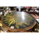 A Victorian walnut tripod table, the circular top with fern ware decoration, 52cm diameter.