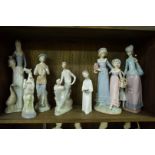 Two Lladro figure groups; together with another Lladro girl; a Nao figure group;