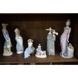 A Lladro figure group; together with three further Nao figures;