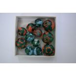 A collection of twelve overlaid green glass spherical beads, largest 2.5cm diameter.