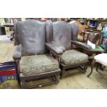 A pair of 1920s faux leather upholstered wing armchairs.