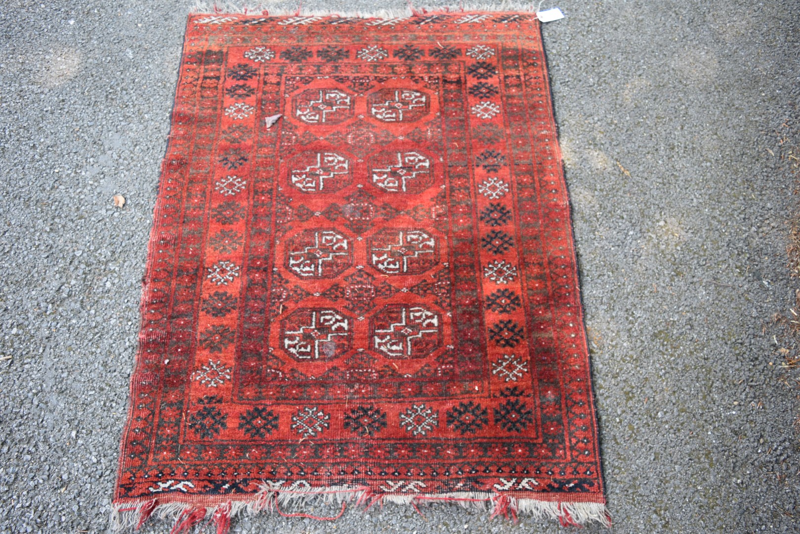 An Afghan rug, with gul design on a red field, 120 x 94cm.