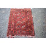 An Afghan rug, with gul design on a red field, 120 x 94cm.