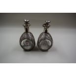 A pair of Hong Kong sterling silver mounted Haig Dimple whisky bottles and stoppers, 26cm.