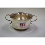 A silver twin handled porringer, by Harrods Ltd, Birmingham 1933, 10cm diameter, 162g.