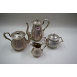 A Continental metal four piece tea set, possibly Flemish, having engine turned decoration,