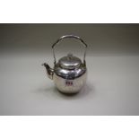 A Japanese metal tea pot, marks to underside and within lid, decorated chrysanthemum,